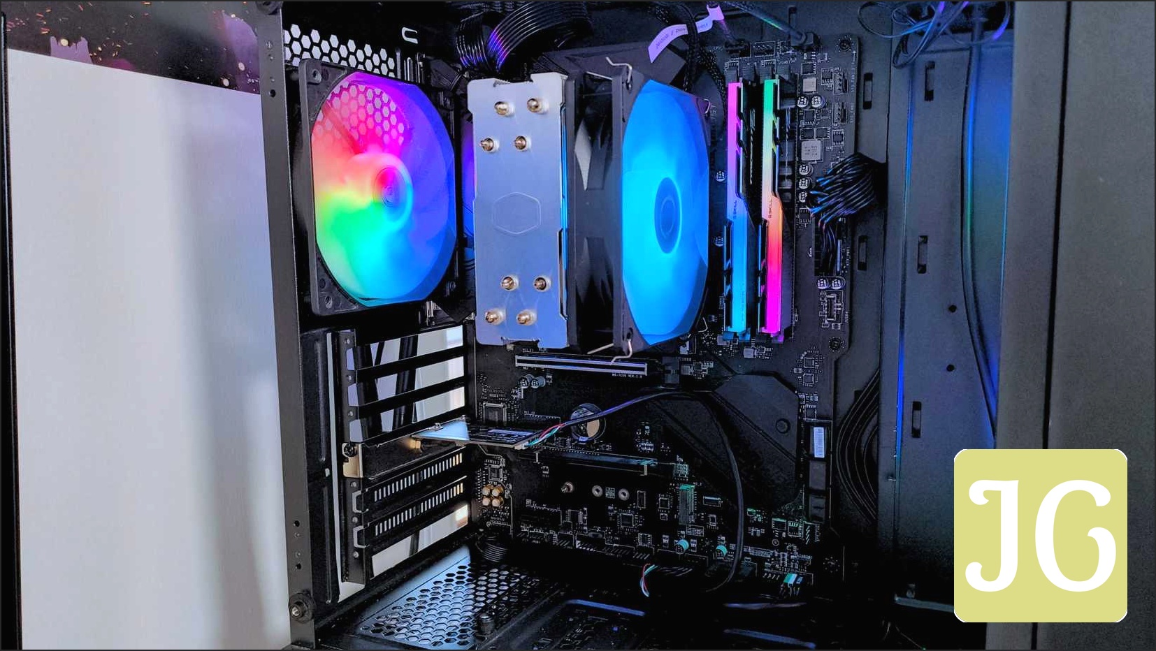 A close up of the interior of a black gaming PC with rainbow RGB fans