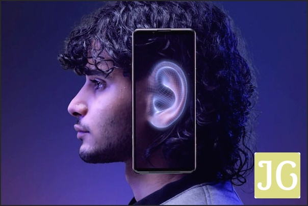 Side-on image of a person with a mobile phone over their ear. The phone screen displays the ear with a blue glow around it