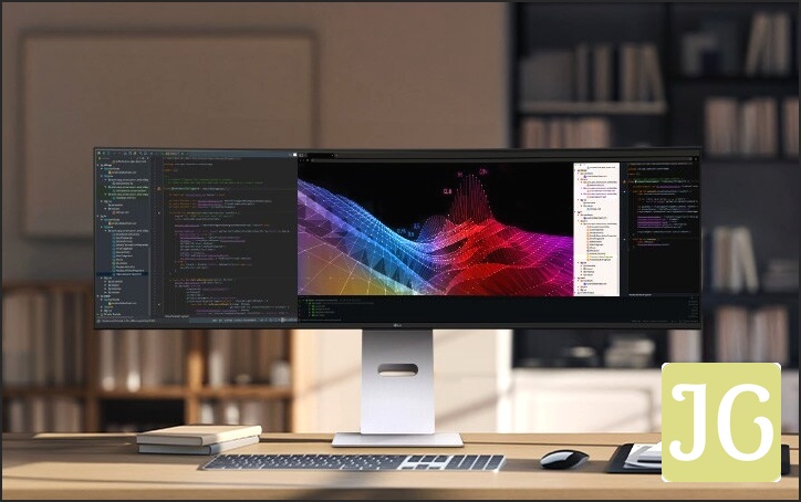 A modern home office setup featuring a large ultra-wide LG monitor displaying data dashboards and graphs, with a wireless keyboard and mouse on a wooden desk.