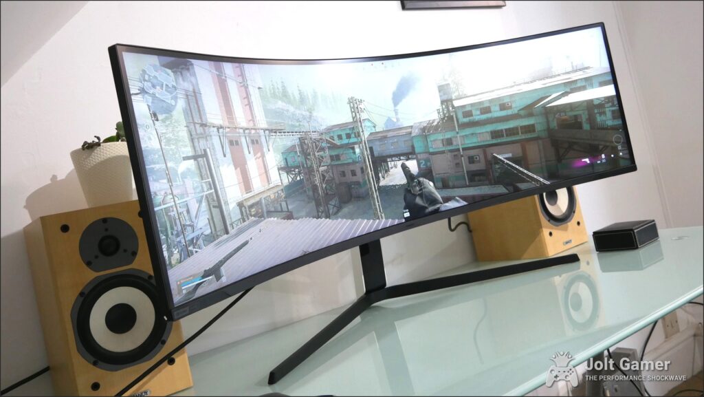 Samsung Odyssey Neo G9 from the front on a desk.