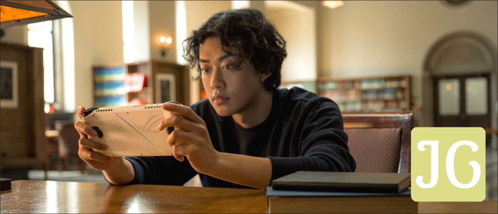 Person sitting in a library, playing with the Ally at a table.